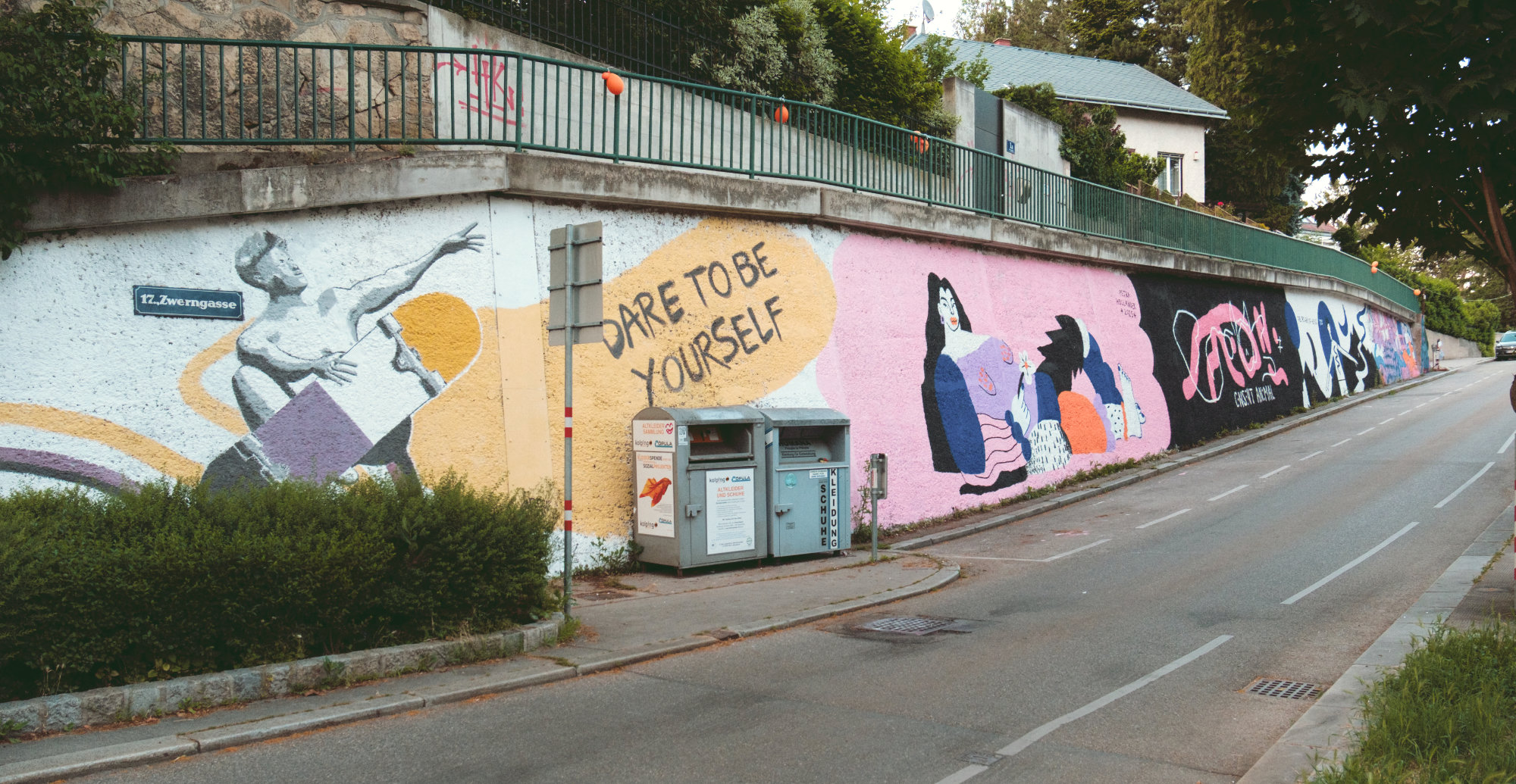 Mural depicting a large woman standing confidently and holding a flower, painted in vivid colors on an outdoor wall. The artwork symbolizes empowerment, self-assurance, and the right to occupy space. Created by four FLINTA artists reclaiming visibility in street art.